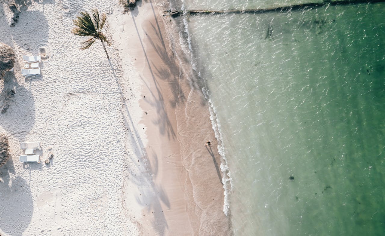 Aerial view of turquoise ocean and white sand beach in Cancun, Mexico